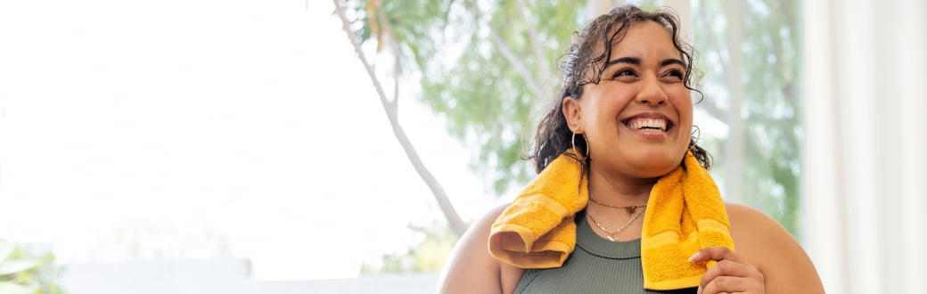 smiling woman with a towel on her shoulder