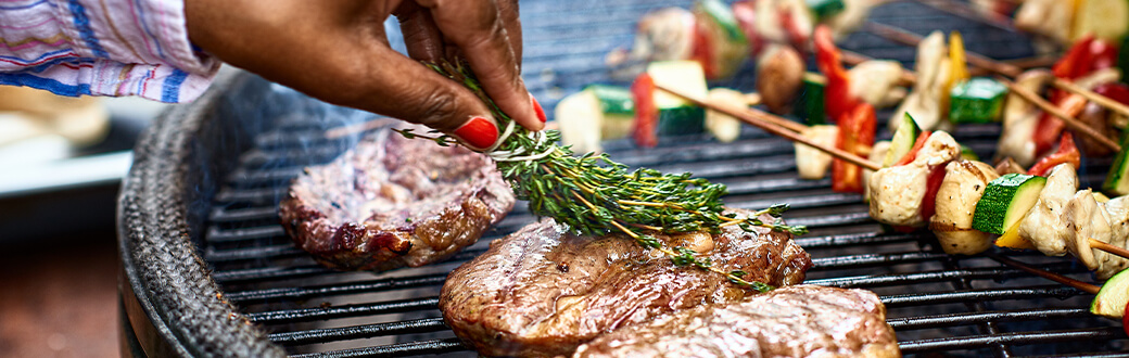 Meat and veggies on a BBQ grill.