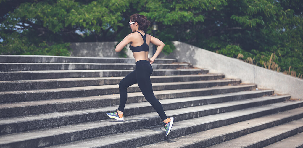 A person jogging up park steps